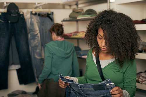 Teen girl shopping for a pair of jeans. 